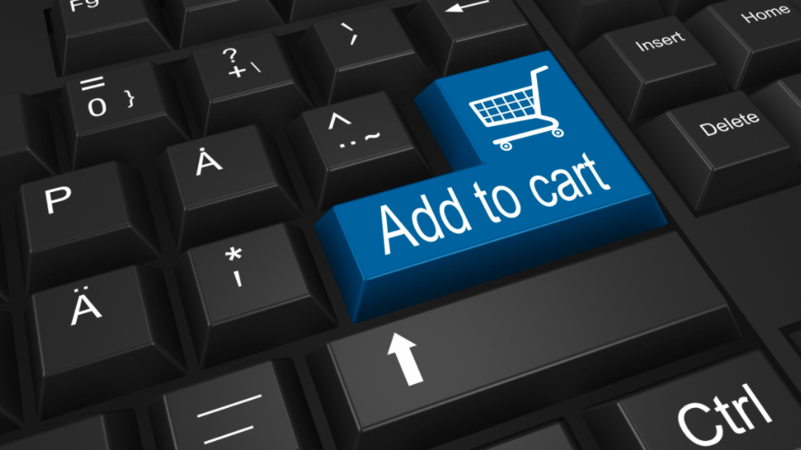 Blue “add to cart” button on a black computer keyboard.