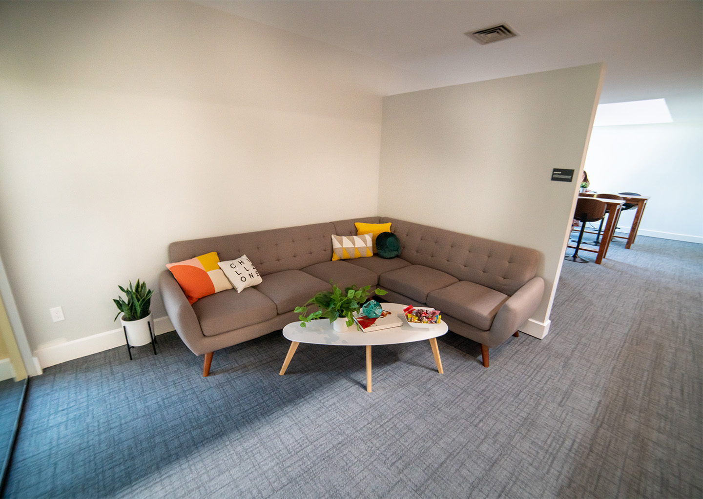 Open office place in Rebel HQ featuring an "L" shaped sectional sofa
